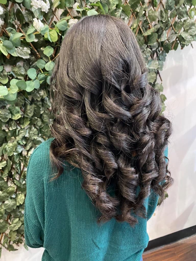 Long brunette hair styled in voluminous curls
